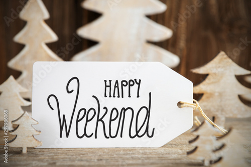 Label With English Text Happy Weekend. White Wooden Christmas Tree As Decoration. Brown Wooden Background