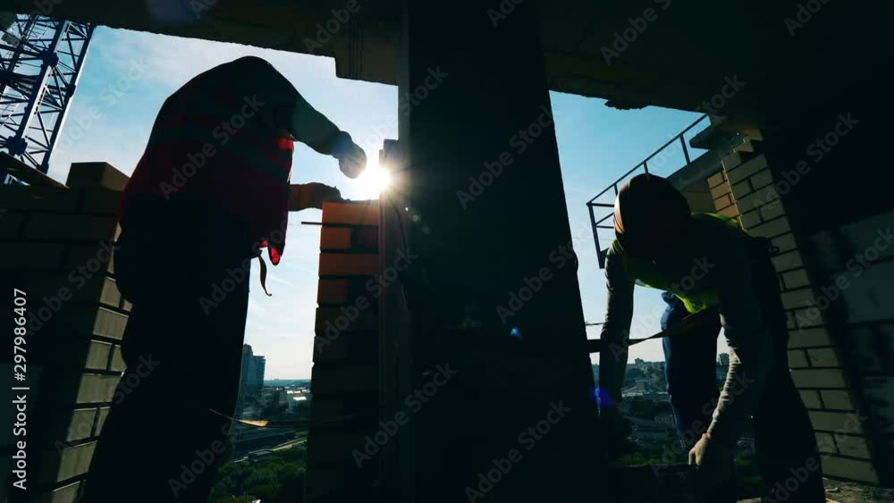 Masonry works held by two engineers in a high-rise building Masonry works held by two engineers in a high-rise building