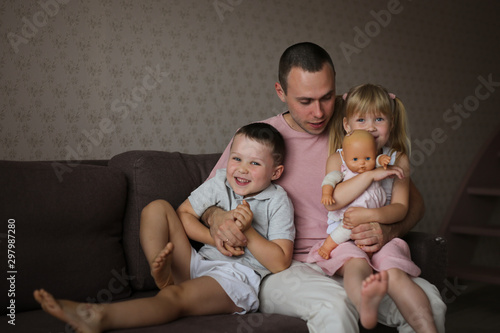 Vászonkép Lonely divorced dad with two children and a doll
