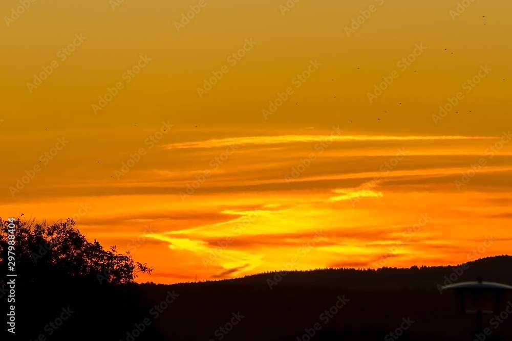 Sunrise closeup over the horizon during a clear summer morning with the orange color giving a beautiful image.