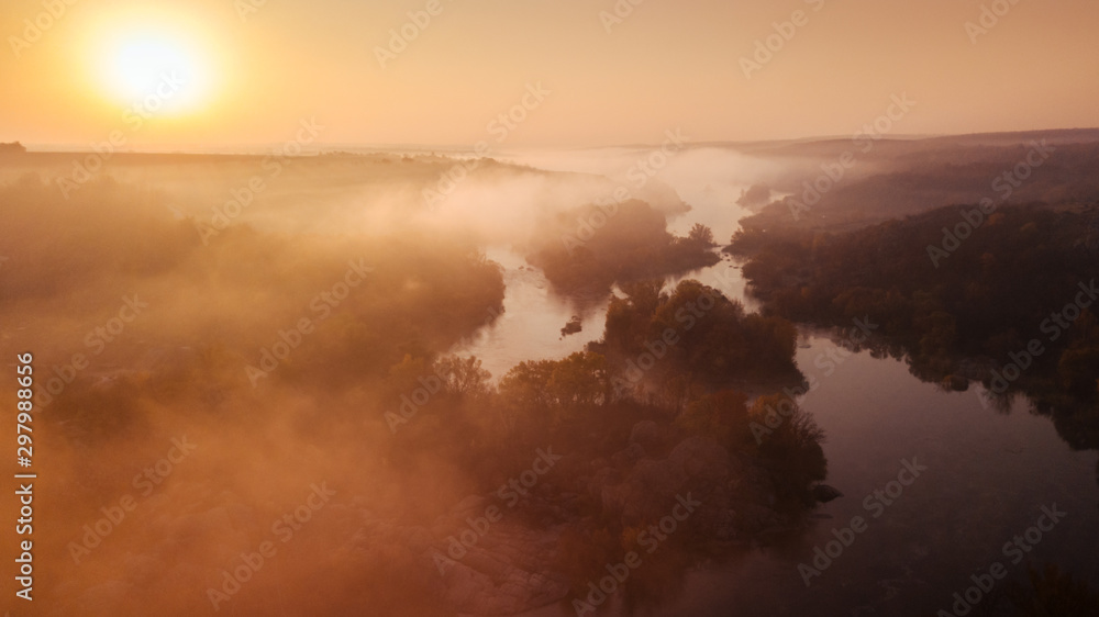 amazing aerial view on sunrise. foggy river and golden trees. beautiful autumn landscape. drone shot, bird's eye amazing aerial view on sunrise. foggy river and golden trees. beautiful autumn landscape. drone shot, bird's eye