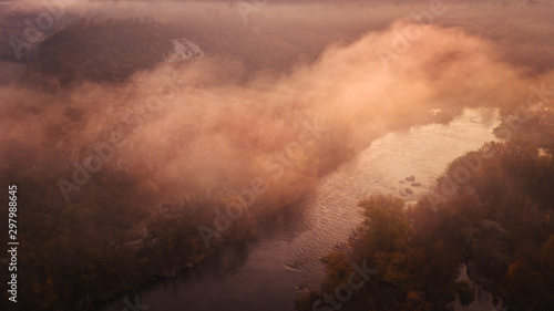 amazing aerial view on sunrise. foggy river and golden  trees. beautiful autumn landscape. drone shot, bird's eye photo