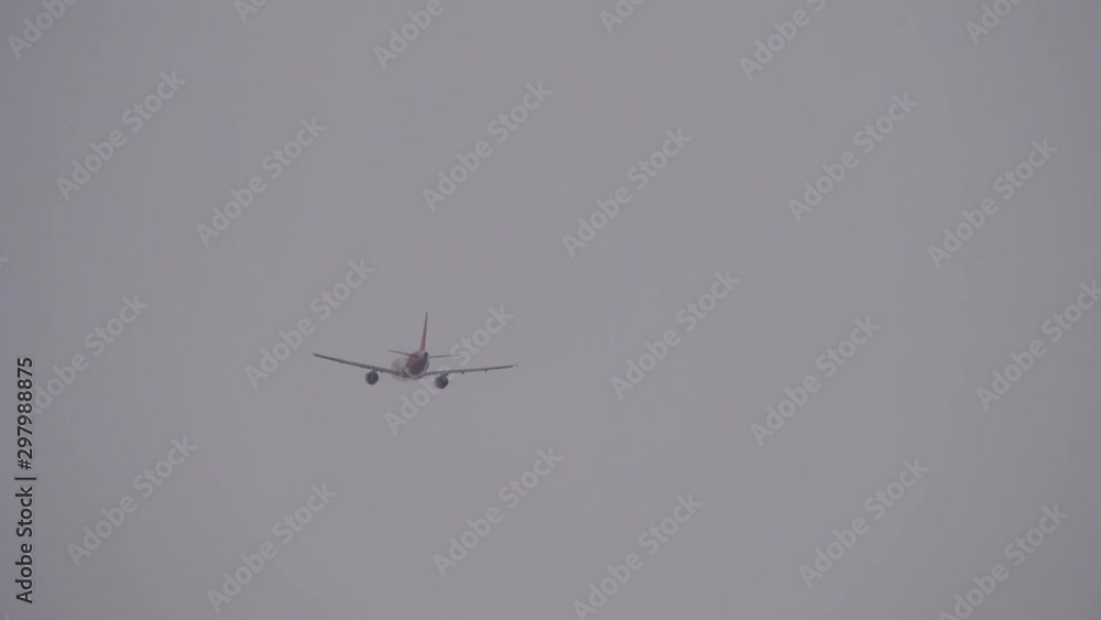 Airplane take off into the sky. Plane flying over head on grey sky. Airplane take off into the sky. Plane flying over head on grey sky.