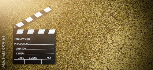 Movie clapper board on gold background
