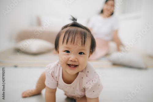portrait of asian mother and baby relaxing in the room