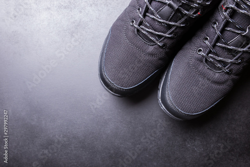 Black men's sneakers close-up on a black isolated background.