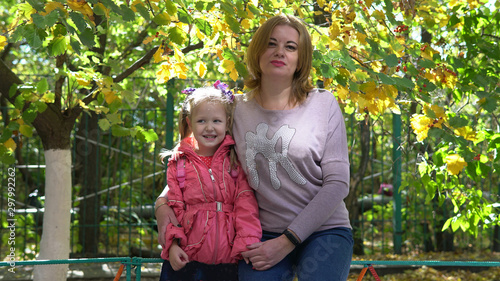 Potrait of preschool kid with teacher on a walk photo