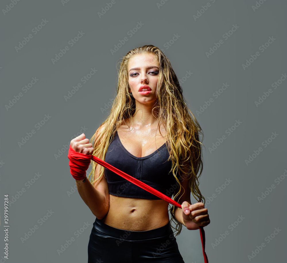 Sporty sexy girl in boxing gloves. Boxer MMA female fighter. Boxer woman.  Beautiful woman with red boxing gloves training. Sportsman, woman boxer  fighting in gloves. Sport, boxing and fitness concept. Stock Photo