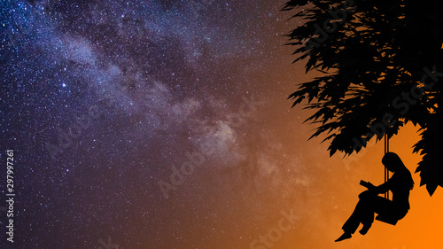 Silhouette of a girl reading in a swing under a tree, in a background with a transition from orange into the Milky Way, a 3D rendering