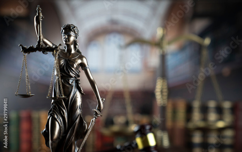  Law and justice theme. Gavel of the judge, Themis statue and the scale on court library background.