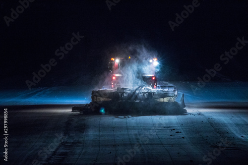 snowcat working on the slope in night