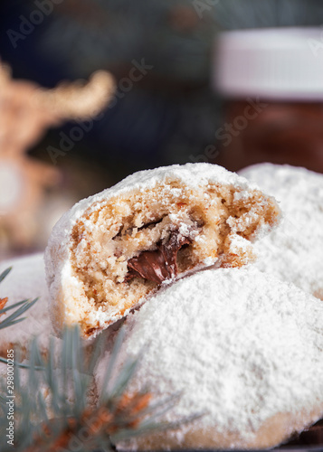 Traditional Christmas cookies biscuits snowballs covered icing sugar povder with almond nut, nutella chocolate an raspberry jam. Christmas New Year ornament decorations. photo