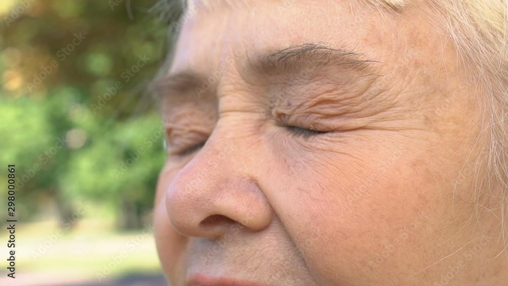 Desperate old female closing eyes, sad memories, painful thoughts, nostalgia Desperate old female closing eyes, sad memories, painful thoughts, nostalgia