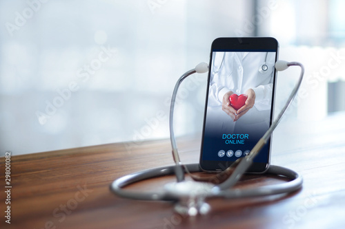 Fototapeta Naklejka Na Ścianę i Meble -  Stethoscope wear with smartphone, Doctor through the phone screen check health. Online medical consultation, online medical and medicine clinic connect and communication with patient, doctor online