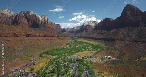 Аerial camera moves over the settlement near a busy highway at the bottom of the gorge (Zion National Park, Utah, USA) photo