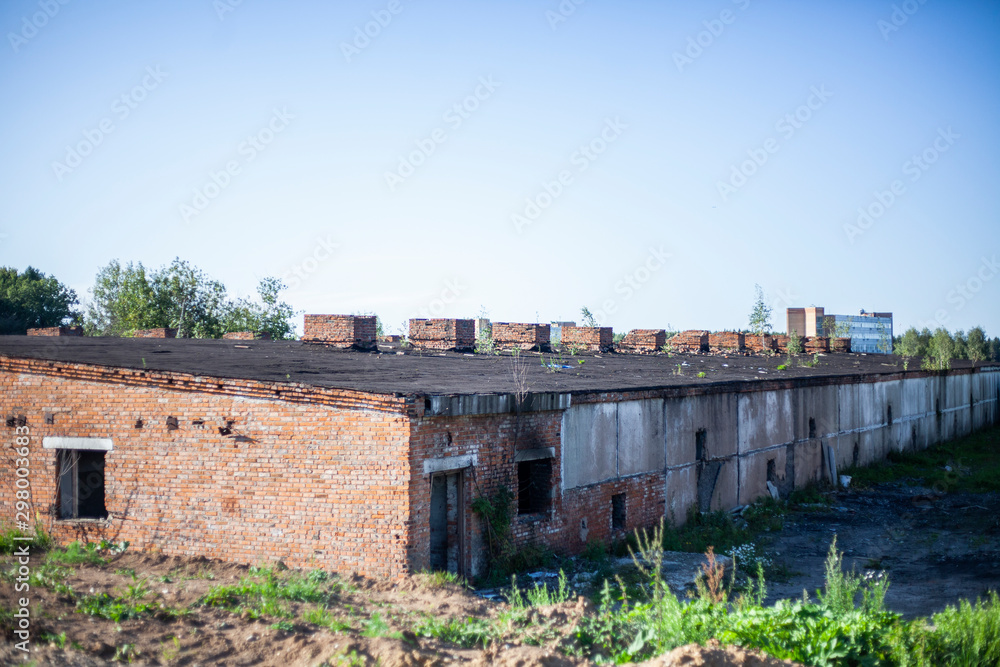 The roof of the old building. Abandoned building. A livestock farm has long been empty. Devastation in the Soviet Union. After the collapse of the USSR, abandoned industries remained.