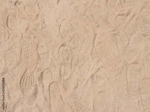 Sand background texture with shoe marks © washarapong