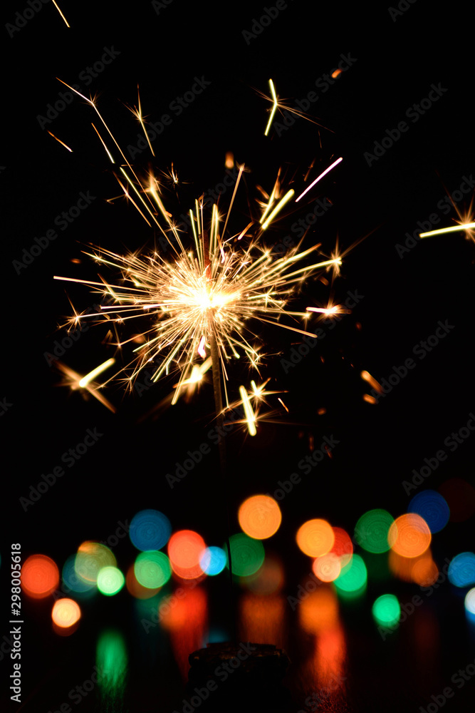 Obraz premium Bengal fire burning on a color blurred background.