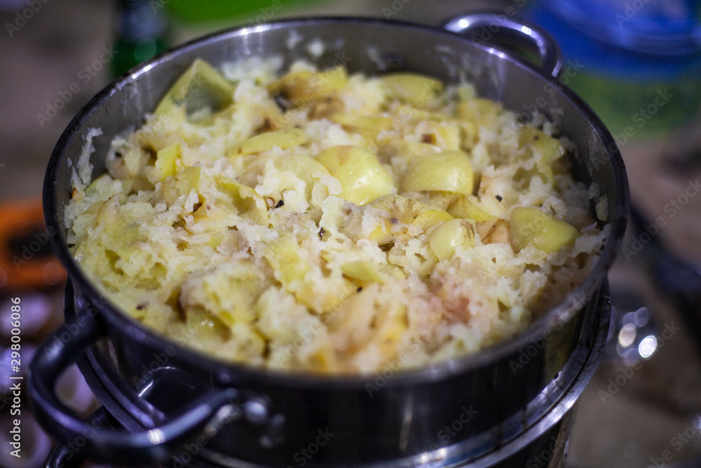 Apples are stewed in a saucepan. Cooking apples. Casserole for cooking products. Apples are cut into pieces and stacked in a bowl. Apples are stewed in a saucepan. Cooking apples. Casserole for cooking products. Apples are cut into pieces and stacked in a bowl.