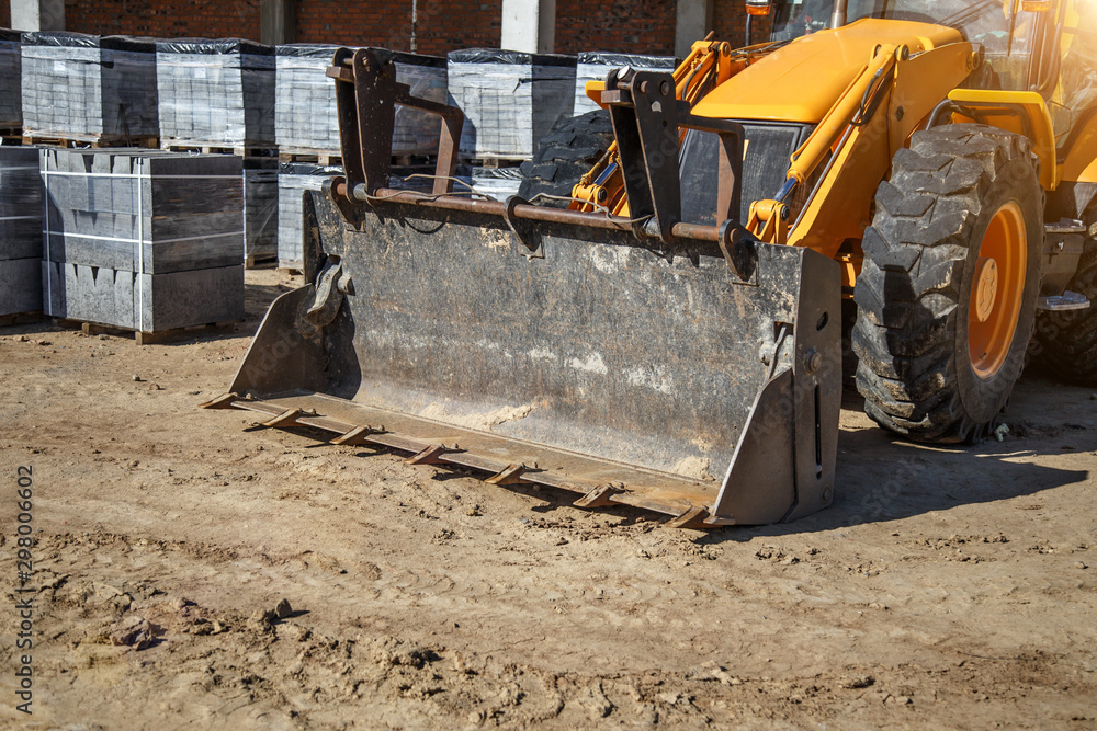 The bulldozer moves and spreads the soil and rubble on the embankment of the road.Bulldozer working on Dirt in the Construction Site.Road under construction. The bulldozer moves and spreads the soil and rubble on the embankment of the road.Bulldozer working on Dirt in the Construction Site.Road under construction.