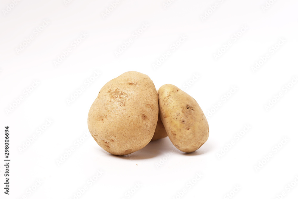 Three fresh brown potatoes raw isolated white background Three fresh brown potatoes raw isolated white background