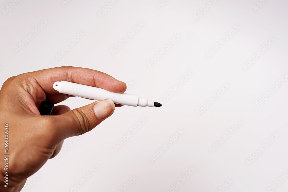 Small black marker hold by hand Small black marker hold by hand