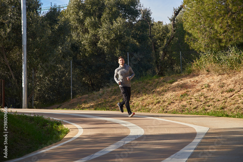 Wallpaper Mural Man jogging on a road around a corner Torontodigital.ca