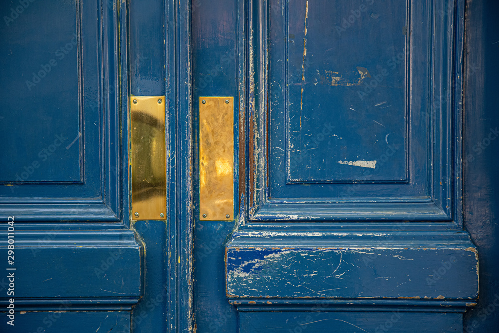 Old blue door. Shabby blue painted wooden door panels closeup. Shiny gold  colored metal plates on rough aged wood surface of doorway. Antique  textures. Architectural details of Paris door Photos | Adobe