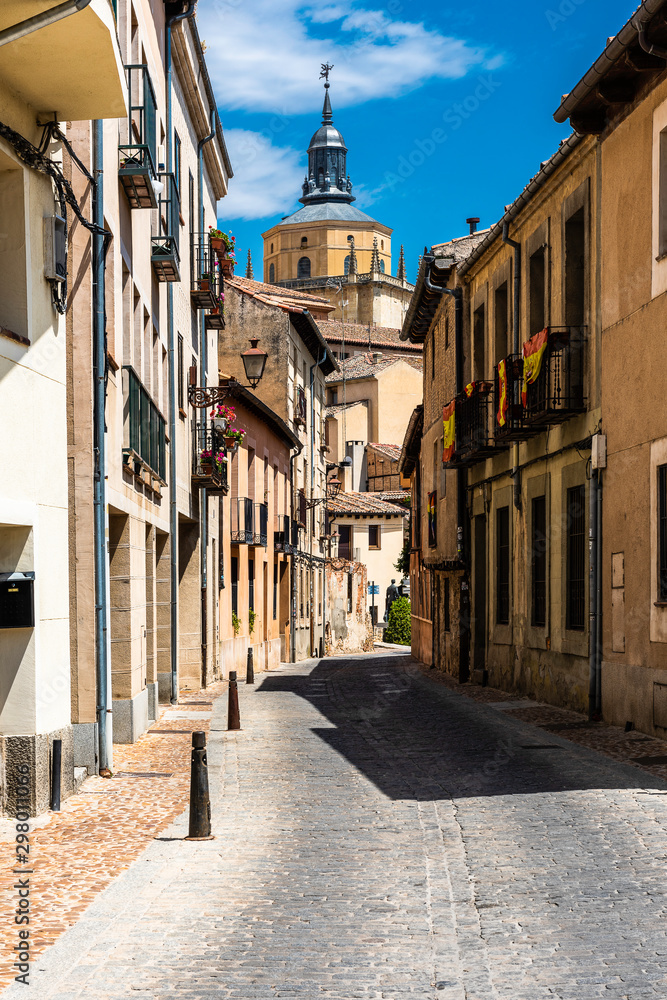 One of the many narrow streets in the city of Segovia in Spain