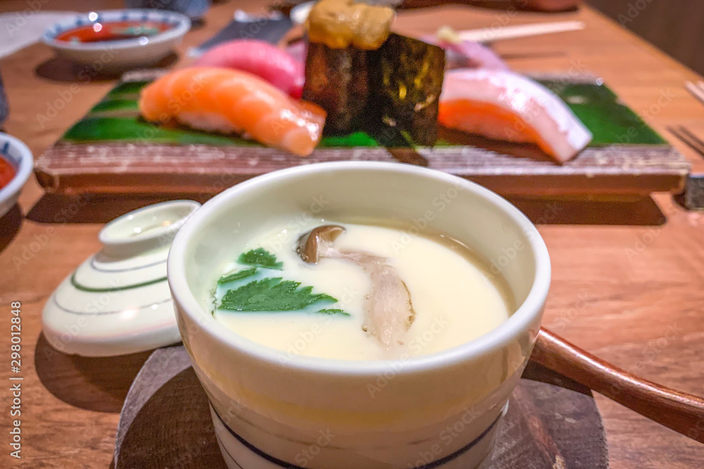 Steamed egg, sushi urchin, salmon, scallop sushi in Japanese restaurant Steamed egg, sushi urchin, salmon, scallop sushi in Japanese restaurant