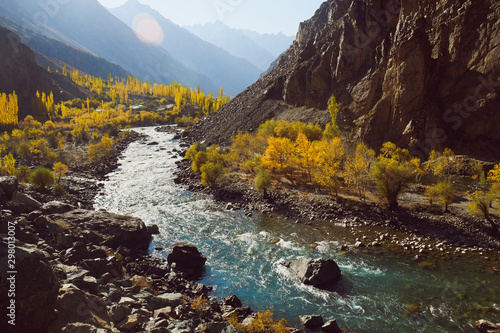 Beautiful nature landscape view of winding river flowing along valley in Hindu Kush mountain range. Autumn season in Gupis Ghizer, Gilgit Baltistan, Pakistan. photo