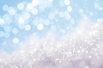 Snow and lights on blue background. Christmas abstract card.