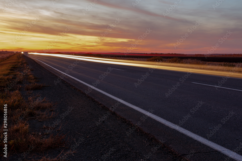 sunset road on a background of colorful sky