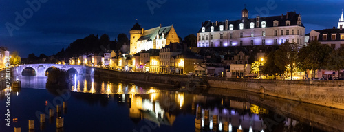 Scenic medieval town of Laval on the banks of the river Mayenne lit up at at night