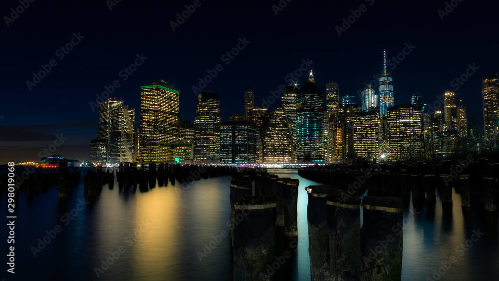 Lower Manhattan at night with the old pier posts
