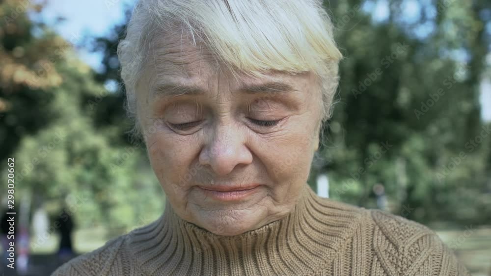 Mature unhappy woman crying outdoors, old age problems, loneliness despair Mature unhappy woman crying outdoors, old age problems, loneliness despair