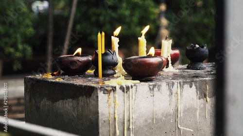 Candles burning outside of ancient temple. photo