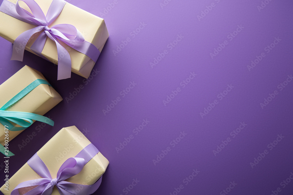 top view of gift boxes with colorful ribbons and bows on purple background  with copy space Stock Photo | Adobe Stock