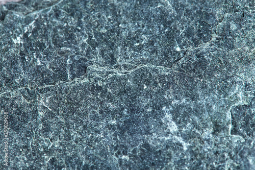 Grainy texture of greenish-gray natural stone. Natural backgrounds and textures. Decor and design. Horizontal.