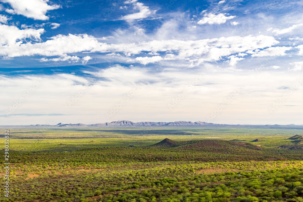 Scenic landscape of the Erongo region with blue sky, green trees and mountains at the horizon, Namibia, Africa