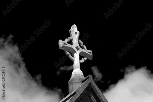 A sun lit church stone Cruc...