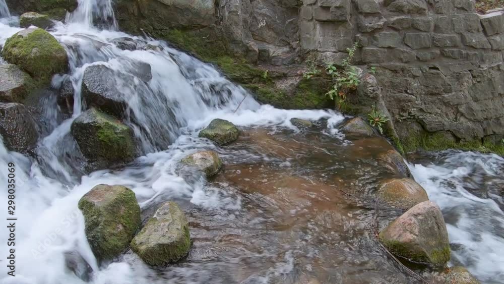 Close-up of A Small Waterfall With Big Mossy Rocks Close-up of A Small Waterfall With Big Mossy Rocks