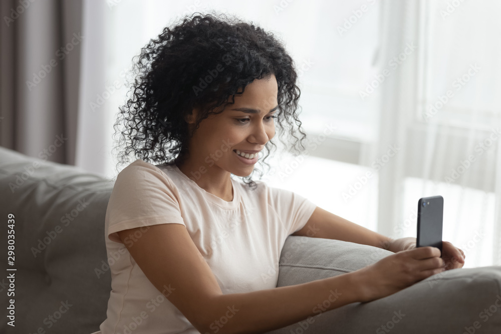 Smiling black young woman using cellphone making selfie Smiling black young woman using cellphone making selfie
