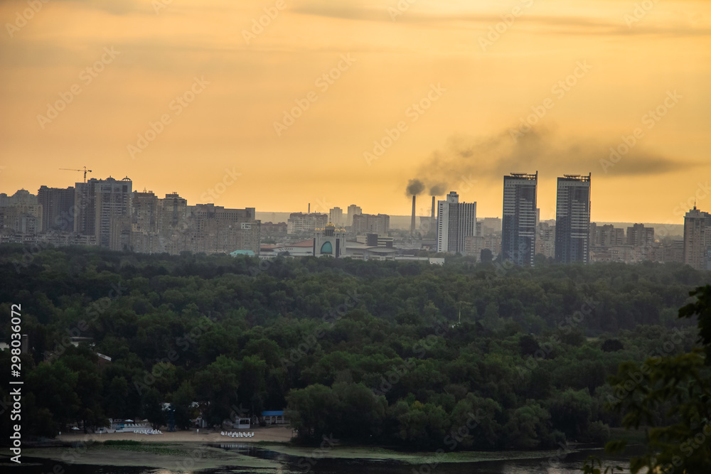 Tour of Kiev in the center of Europe. View of the Dnieper, Trukhanov island and a foot bridge. Park fountain and sunset on the horizon..