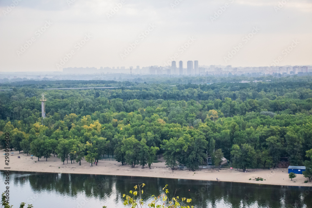 Obraz premium Tour of Kiev in the center of Europe. View of the Dnieper, Trukhanov island and a foot bridge. Park fountain and sunset on the horizon..