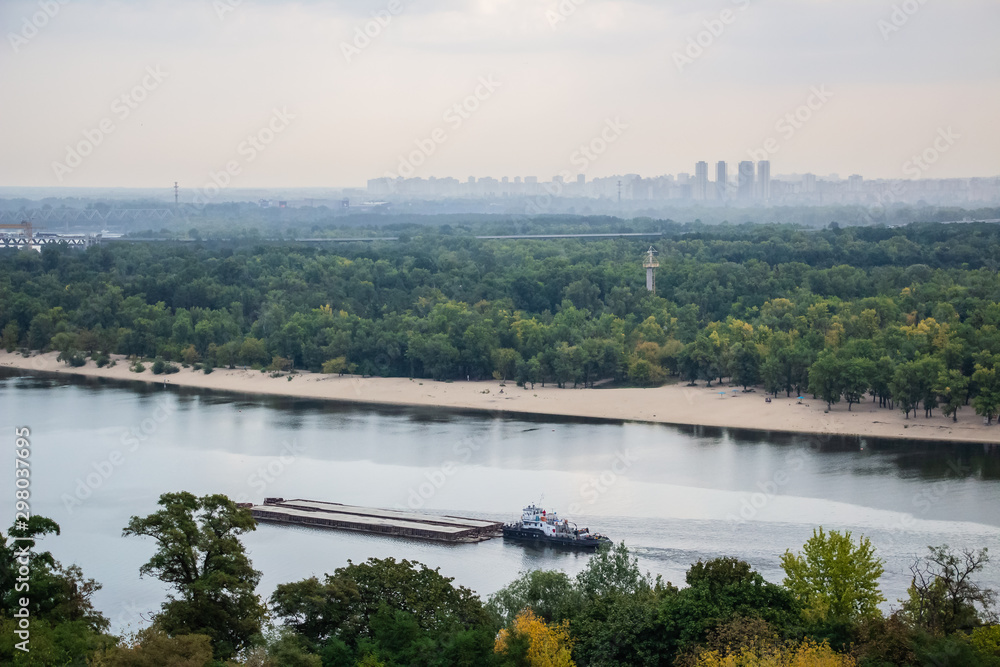 Obraz premium Tour of Kiev in the center of Europe. View of the Dnieper, Trukhanov island and a foot bridge. Park fountain and sunset on the horizon..