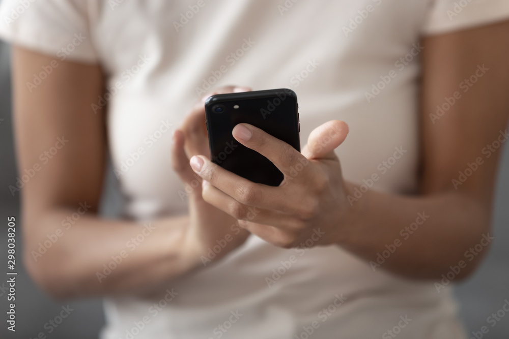 Close up of black woman using smartphone messaging Close up of black woman using smartphone messaging