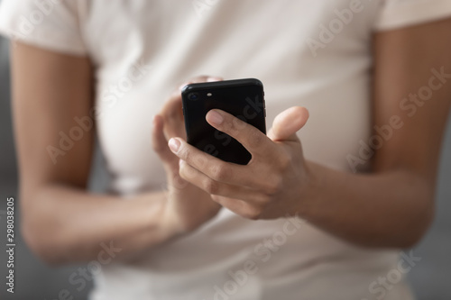 Close up of black woman using smartphone messaging