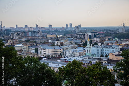 Tour of Kiev in the center of Europe. View of the Dnieper, Trukhanov island and a foot bridge. Park fountain and sunset on the horizon..