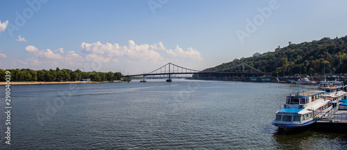 Tour of Kiev in the center of Europe. View of the Dnieper, Trukhanov island and a foot bridge. Park fountain and sunset on the horizon..